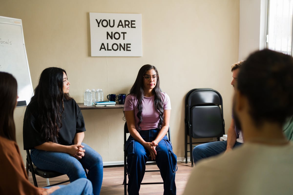 Women sitting in a circle, listening and supporting one another